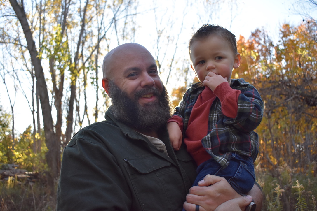 Joel, founder of Quickwire, holding his son